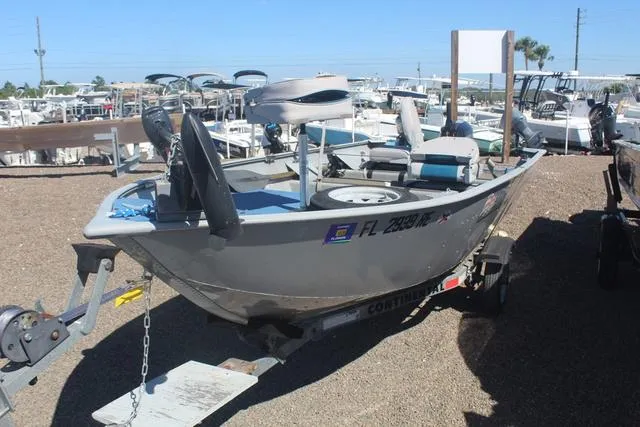 Slide: The Image of 2016 Tracker Guide V-14 Deep V boat on trailer in a marina. - 3