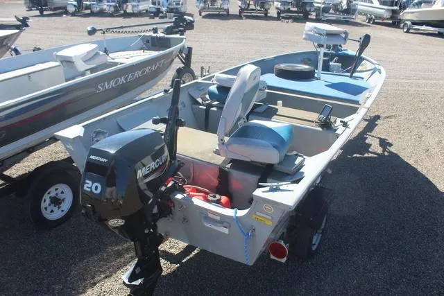 Slide: The Image of 2016 Tracker Guide V-14 Deep V boat with Mercury 20 engine, parked on gravel. - 6
