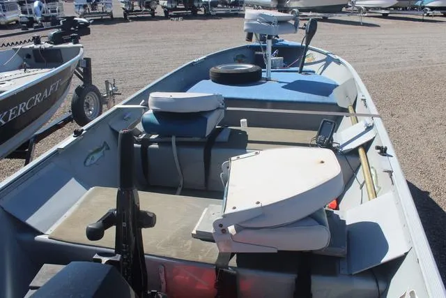 Slide: The Image of 2016 Tracker Guide V-14 Deep V boat with seating and equipment on a gravel lot. - 7