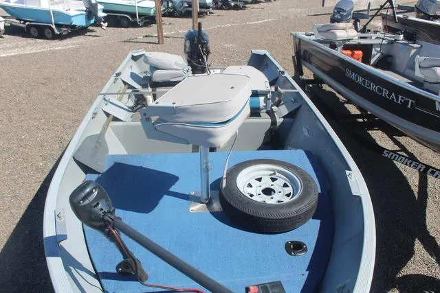 Slide: The Image of 2016 Tracker Guide V-14 Deep V boat with blue interior and spare tire on deck. - 8