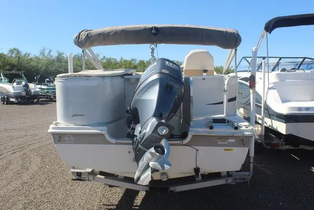 Slide: The Image of 2007 Hurricane FunDeck 196 RE3 boat with outboard motor, parked on gravel. - 5