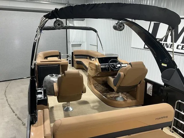 Slide: The Image of 2025 Harris GRAND MARINER 250 SLDH pontoon boat interior with tan seating and modern helm. - 13