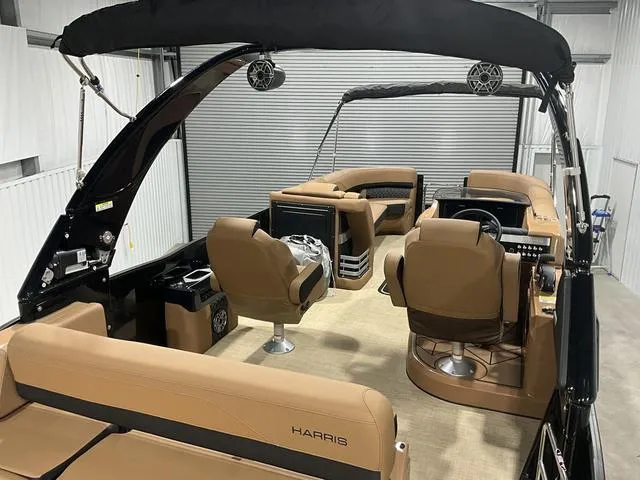 Slide: The Image of 2025 Harris GRAND MARINER 250 SLDH pontoon boat interior with tan seating and modern design. - 14