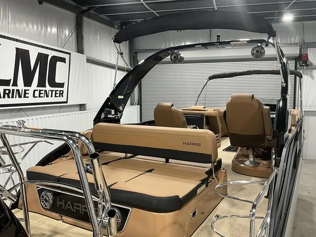 Slide: The Image of 2025 Harris GRAND MARINER 250 SLDH pontoon boat in showroom, featuring sleek design and luxury seating. - 15