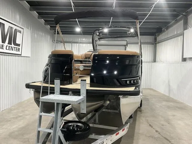 Slide: The Image of 2025 Harris GRAND MARINER 250 SLDH pontoon boat in showroom, rear view. - 2