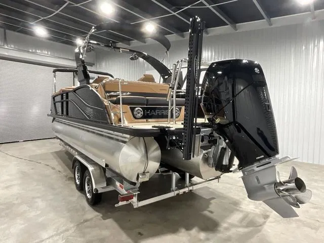 Slide: The Image of 2025 Harris GRAND MARINER 250 SLDH pontoon boat in a showroom, rear view. - 3