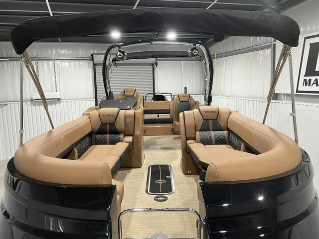 Slide: The Image of 2025 Harris GRAND MARINER 250 SLDH pontoon boat with luxurious tan seating and sleek design. - 6