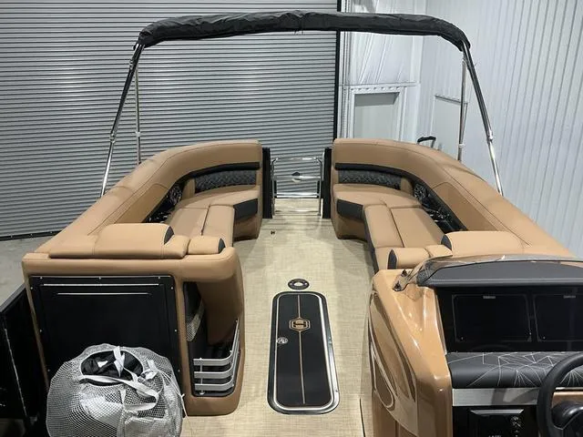 Slide: The Image of 2025 Harris GRAND MARINER 250 SLDH pontoon boat with tan seating and sleek interior design. - 9