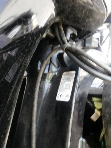 Slide: The Image of Close-up of a 2022 Tracker Pro 170 boat engine with visible cables and label. - 8