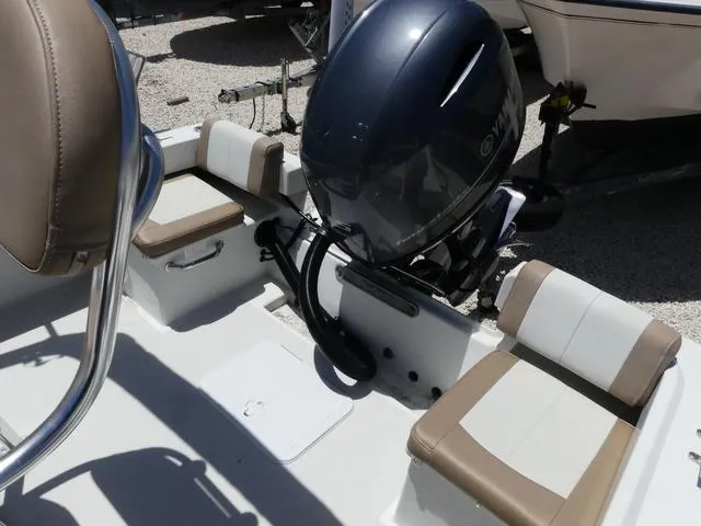 Slide: The Image of 2019 Parker 1801 CC boat interior with Yamaha outboard motor and cushioned seating. - 10