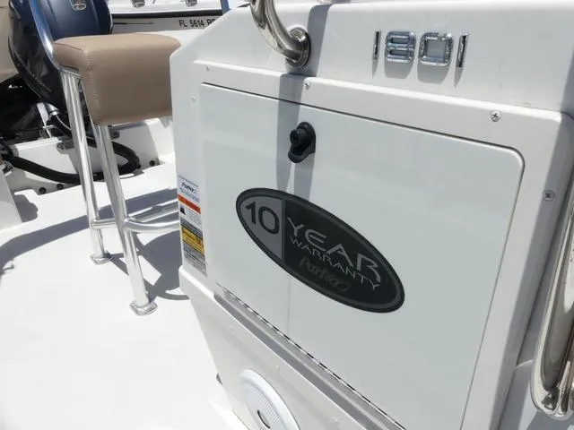 Slide: The Image of 2019 Parker 1801 CC boat with 10-year warranty badge, beige seat, and white deck. - 13