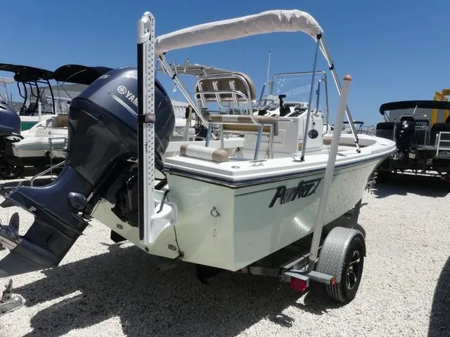 Slide: The Image of 2019 Parker 1801 CC boat with Yamaha outboard motor on a trailer, parked on gravel. - 4