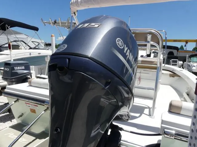 Slide: The Image of 2019 Parker 1801 CC boat with Yamaha 115 outboard motor, docked under clear blue sky. - 5