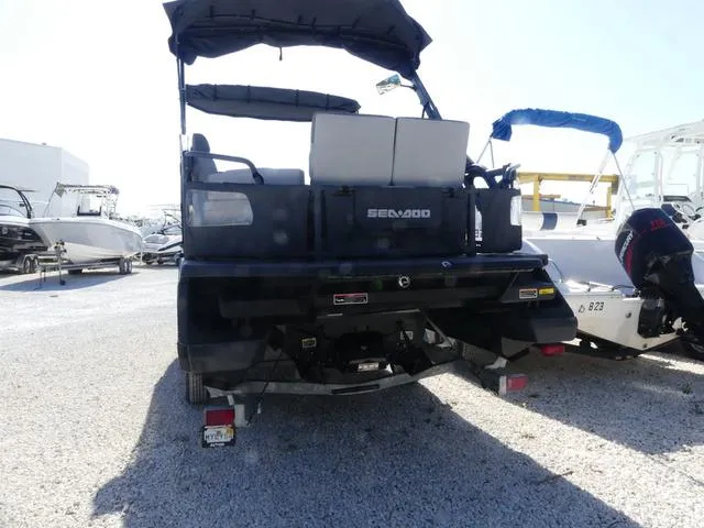 Slide: The Image of 2023 Sea-Doo Switch® 16-130 hp pontoon boat, rear view in a marina. - 4