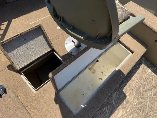 Slide: The Image of 2000 Lund 1475 Rebel boat interior with open storage compartments and seating. - 13