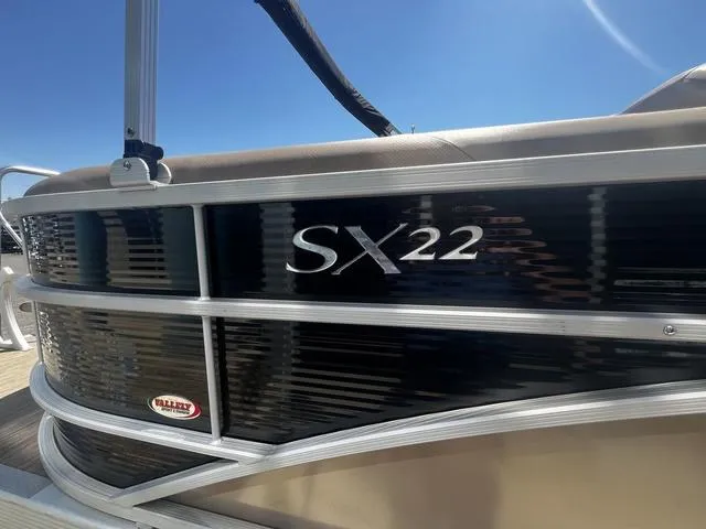 Slide: The Image of 2022 Bennington 22 SXSR Tri-Toon Pontoon boat, side view with SX22 logo. - 10