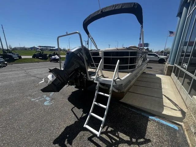 Slide: The Image of 2022 Bennington 22 SXSR Tri-Toon Pontoon with ladder and canopy in parking lot. - 11