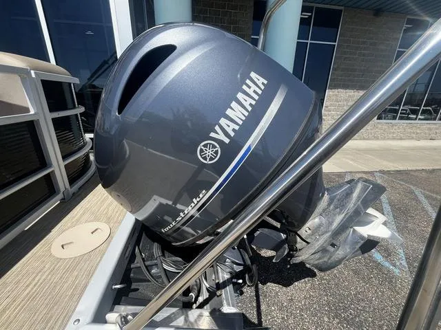 Slide: The Image of 2022 Bennington 22 SXSR Tri-Toon Pontoon with Yamaha outboard motor, parked outdoors. - 12