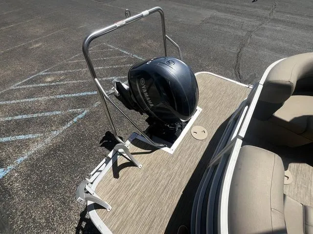 Slide: The Image of 2022 Bennington 22 SXSR Tri-Toon Pontoon with Yamaha outboard motor, docked on pavement. - 13