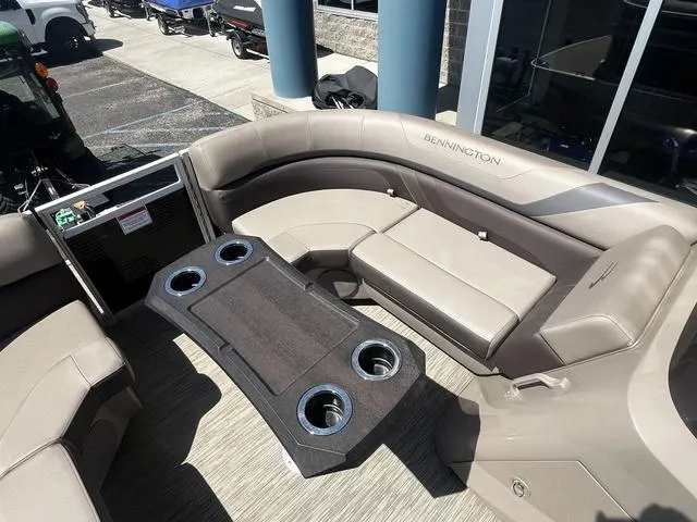 Slide: The Image of 2022 Bennington 22 SXSR Tri-Toon Pontoon interior with seating and table, showcasing luxury design. - 19