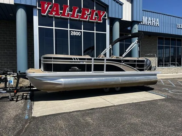 Slide: The Image of 2022 Bennington 22 SXSR Tri-Toon Pontoon displayed outside Vallely dealership. - 2