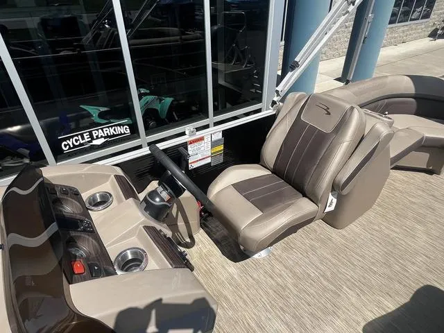 Slide: The Image of 2022 Bennington 22 SXSR Tri-Toon Pontoon boat interior with helm and seating area. - 20
