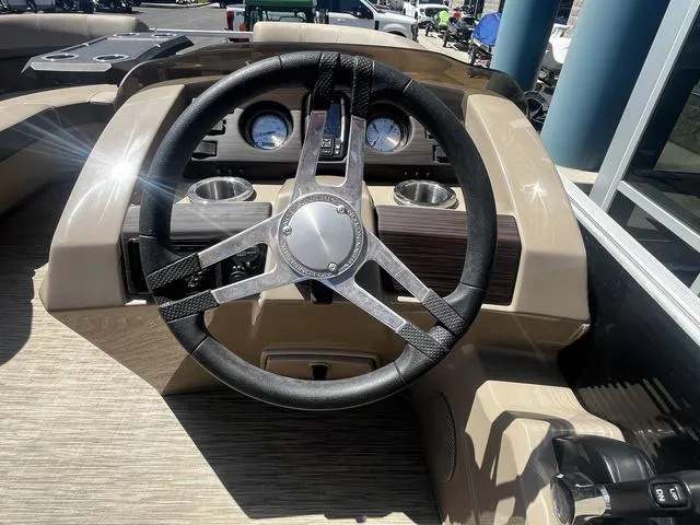 Slide: The Image of 2022 Bennington 22 SXSR Tri-Toon Pontoon steering wheel and dashboard close-up. - 24