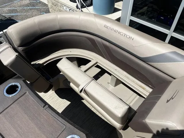 Slide: The Image of 2022 Bennington 22 SXSR Tri-Toon Pontoon seating area with cup holders, beige upholstery. - 26