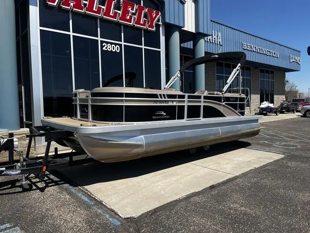 Slide: The Image of 2022 Bennington 22 SXSR Tri-Toon Pontoon boat displayed outside dealership. - 3