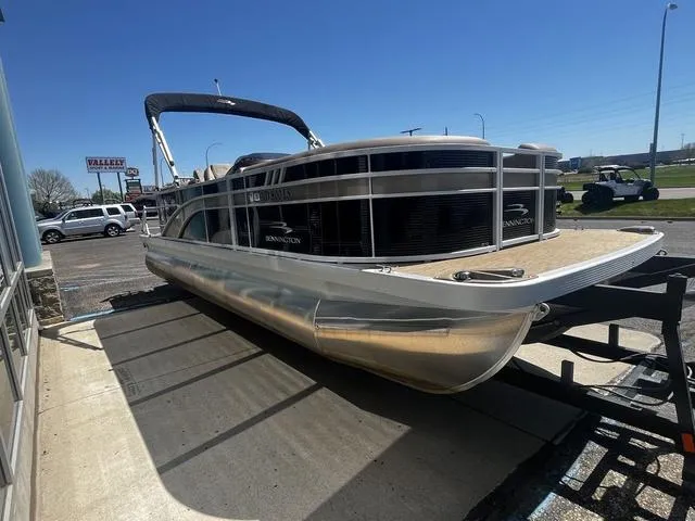 Slide: The Image of 2022 Bennington 22 SXSR Tri-Toon Pontoon on trailer, parked outdoors under clear blue sky. - 6