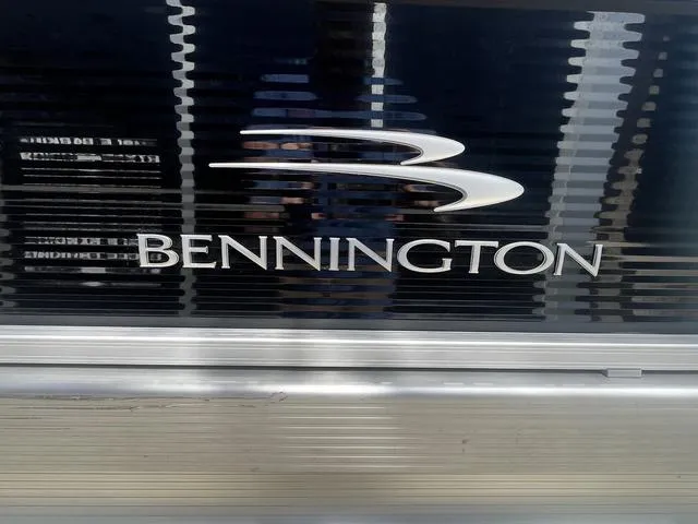 Slide: The Image of 2022 Bennington 22 SXSR Tri-Toon Pontoon logo on sleek metallic surface. - 7