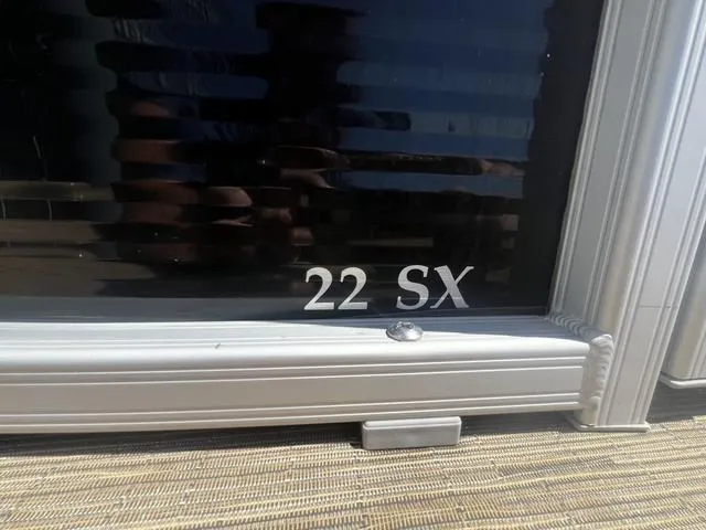 Slide: The Image of 2022 Bennington 22 SXSR Tri-Toon Pontoon, close-up of model name on exterior. - 8