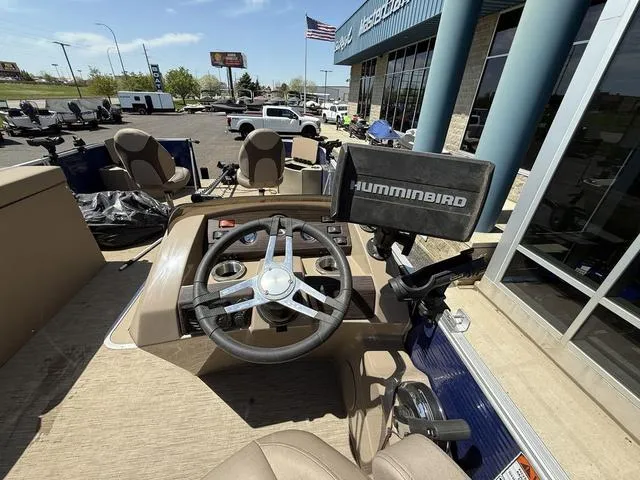 Slide: The Image of 2022 Bennington 23 SFXAPG boat dashboard with steering wheel and Humminbird fish finder. - 17