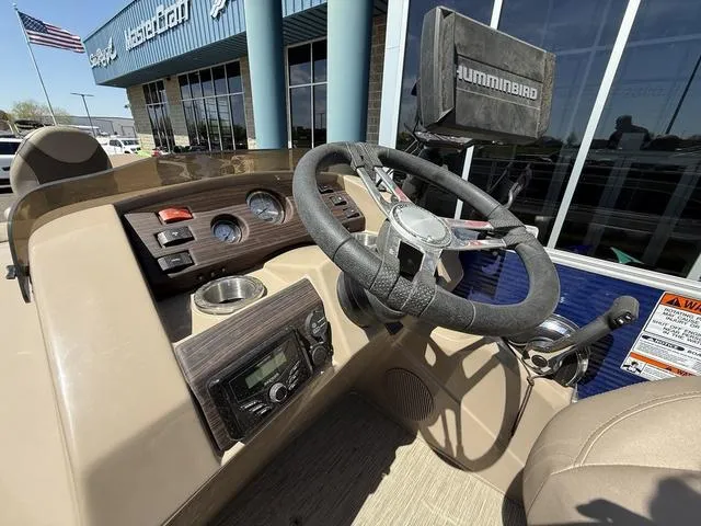 Slide: The Image of 2022 Bennington 23 SFXAPG boat dashboard with steering wheel and Humminbird device. - 18