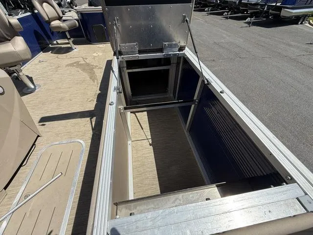 Slide: The Image of 2022 Bennington 23 SFXAPG boat interior with open storage compartment and seating. - 27