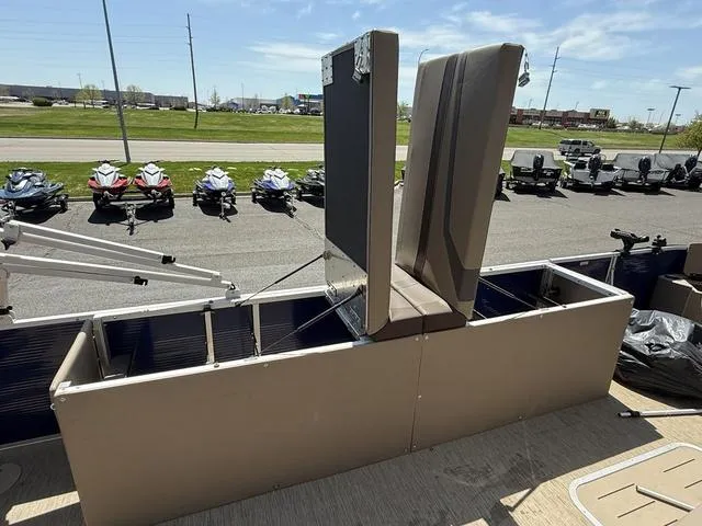 Slide: The Image of 2022 Bennington 23 SFXAPG boat with open storage compartments, displayed outdoors. - 29