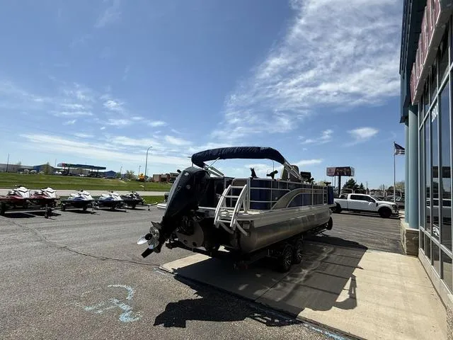 Slide: The Image of 2022 Bennington 23 SFXAPG pontoon boat parked outside dealership on sunny day. - 6