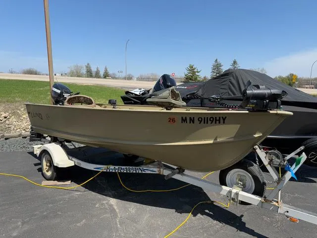 Slide: The Image of 2000 Lund 1475 Rebel boat on trailer, parked outdoors under clear sky. - 2