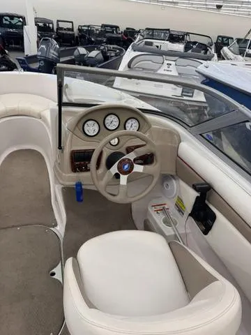 Slide: The Image of 2005 Four Winns 190LE boat interior with steering wheel and white seating. - 10