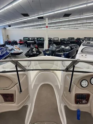 Slide: The Image of 2005 Four Winns 190LE boat interior with white seating and speaker system. - 13