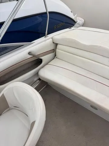 Slide: The Image of 2005 Four Winns 190LE boat interior with white cushioned seating. - 6