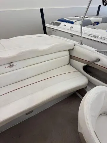 Slide: The Image of 2005 Four Winns 190LE boat interior with white cushioned seating and storage compartments. - 7