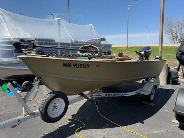 Slide: The Image of 2000 Lund 1475 Rebel boat on trailer, parked outdoors under clear sky. - 3