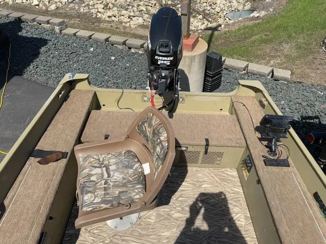 Slide: The Image of 2000 Lund 1475 Rebel boat interior with camo seat and Evinrude motor. - 8