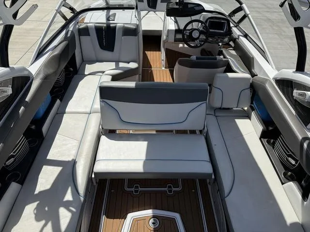 Slide: The Image of 2013 Nautique G23 boat interior with sleek seating and modern dashboard. - 10