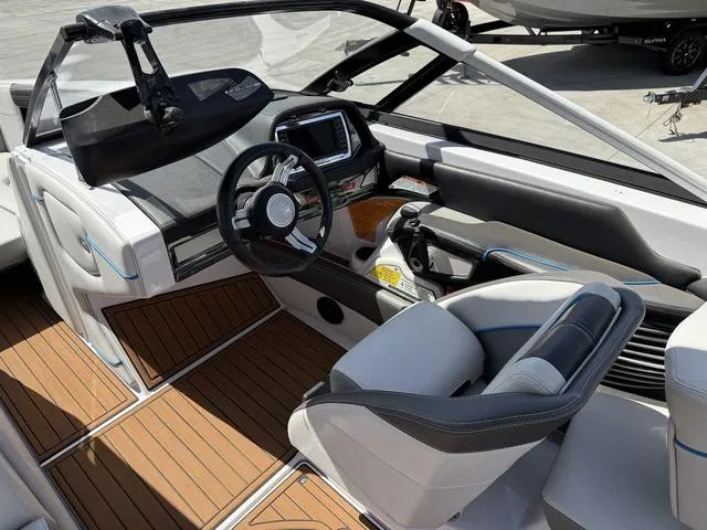 Slide: The Image of 2013 Nautique G23 boat interior with modern dashboard and seating. - 12