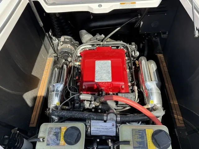 Slide: The Image of Engine compartment of a 2013 Nautique G23 boat with a red engine cover. - 14