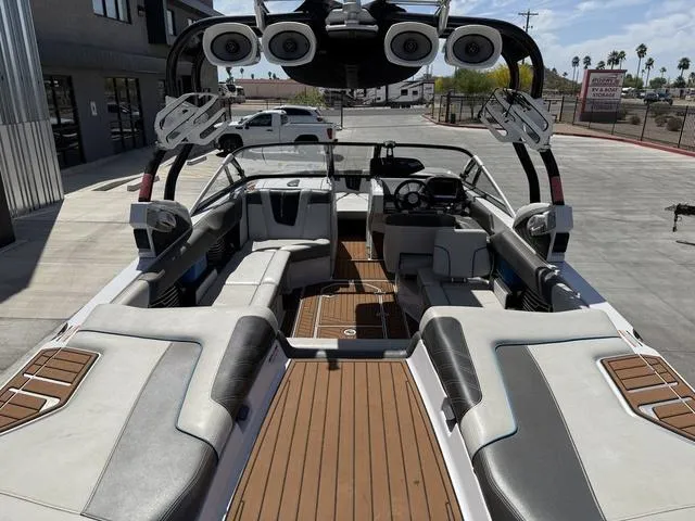 Slide: The Image of 2013 Nautique G23 boat interior with sleek seating and advanced audio system. - 9