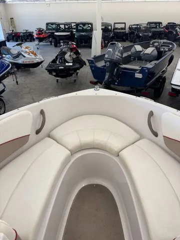 Slide: The Image of 2005 Four Winns 190LE boat interior cabin with cushioned seating and carpeted floor. - 14