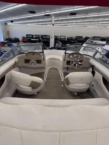 Slide: The Image of 2005 Four Winns 190LE boat interior with beige seating and blue canopy. - 4